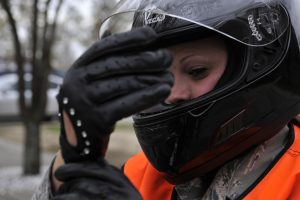 Motorcyclst checking right glove