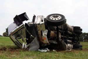 An overturned and badly damaged semi truck