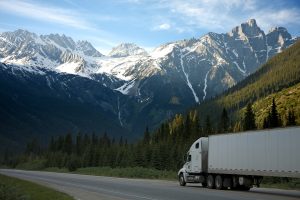 A semi-truck driving in the mountains