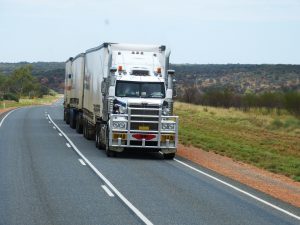 A white triple-trailer semi truck