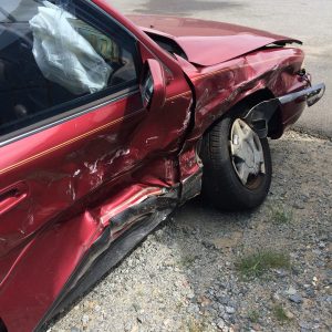 A severely damaged red car