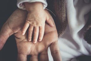 A baby's hand in an adult's hand