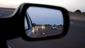 side mirror of a car showing highway