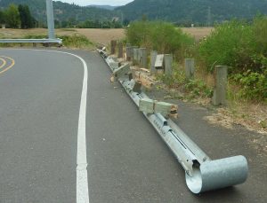 damaged crash barrier at the roadside