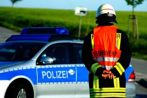 emergency worker standing near emergency vehicle