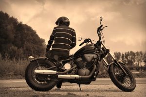 a man sitting on a motorcycle