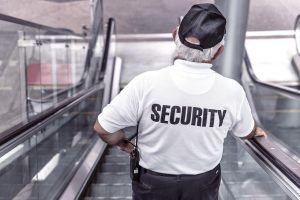 security guard riding an escalator 