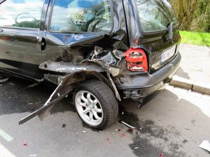 A black minivan with damage to the rear