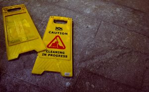 A "caution, cleaning in progress" sign on the floor