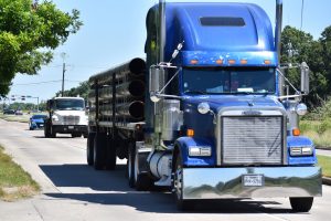 A blue semi carryng pipes