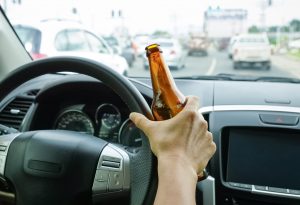 drinking-beer-driving-behind-the-wheel-scaled-1-300x205