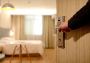 A man opening a hotel room door